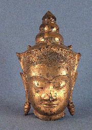 Cabeza de diosa oriental, de metal dorado
