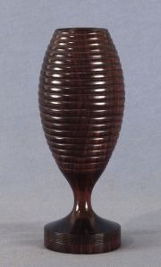 Copa de madera tallada, de forma ovoide con ornamentación de molduras. Alto: 18 cm. Colec. Jacques Barón Supervielle.