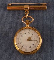 Reloj de dama con prendedor.